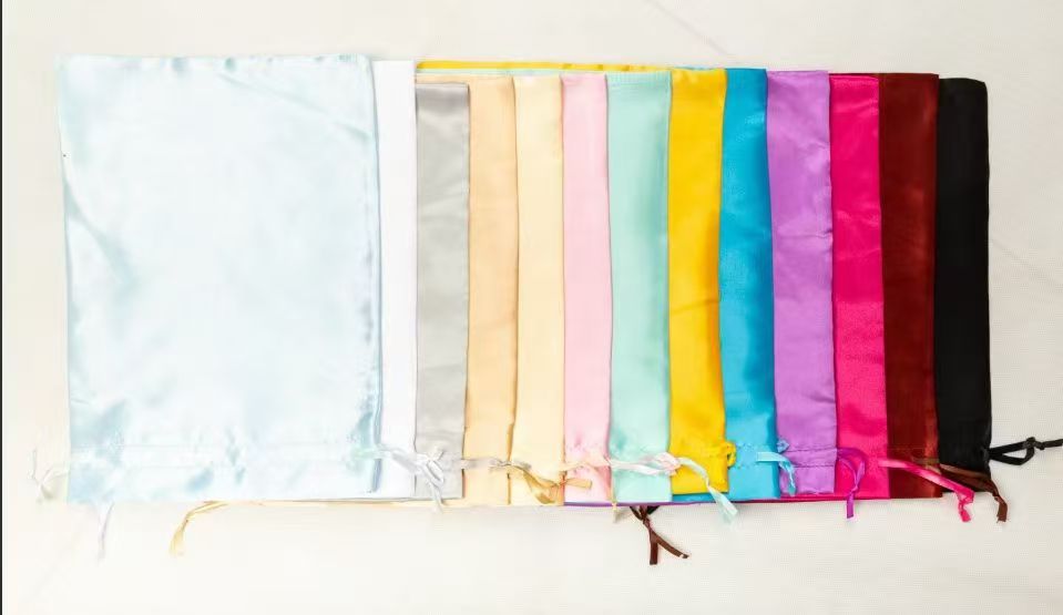 Assorted satin drawstring pouches for luxury hair product packaging