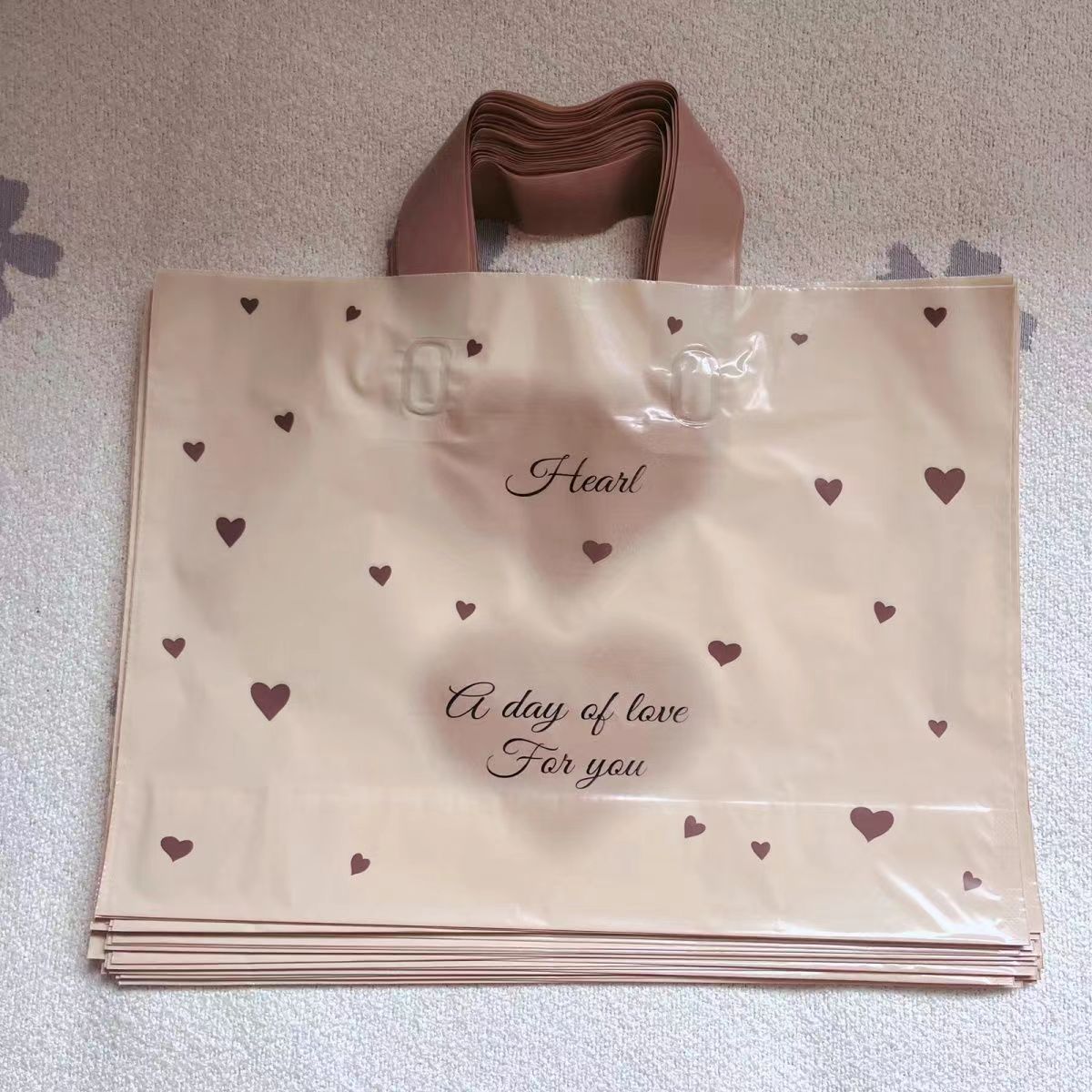 Transparent PE shopping tote bag with brown handles and printed logo